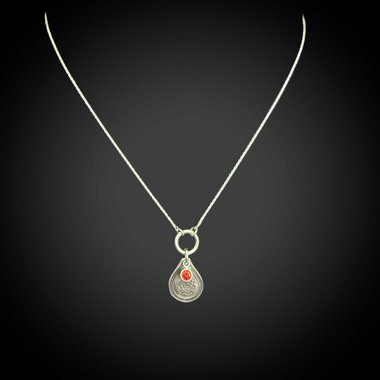 Sterling silver January birth flower necklace with carnation engraving and garnet-red CZ birthstone by Adorn Designs Jewelry.