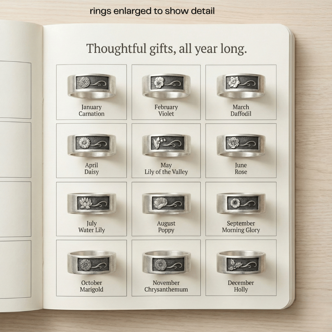 Calendar with silver rings, each corresponding to a month and flower name, on a wooden surface.