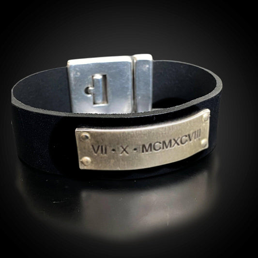 Close view of sterling plate showing custom engraving (fingerprints/handwriting/dates)
