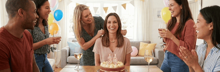friends celebrating 30th birthday with symbolic 3 bead necklace