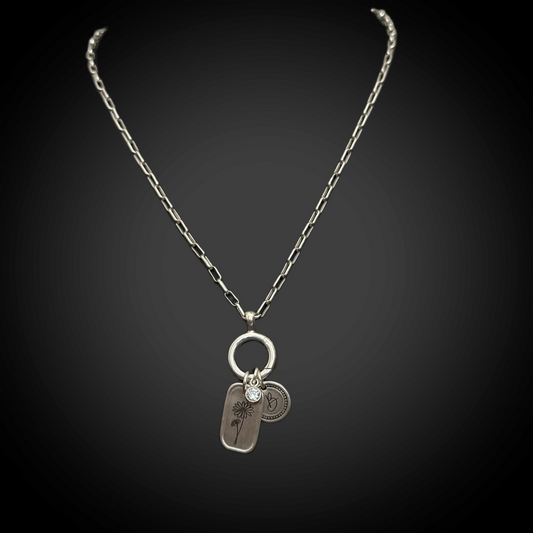 Necklace with two pendants on a dark background