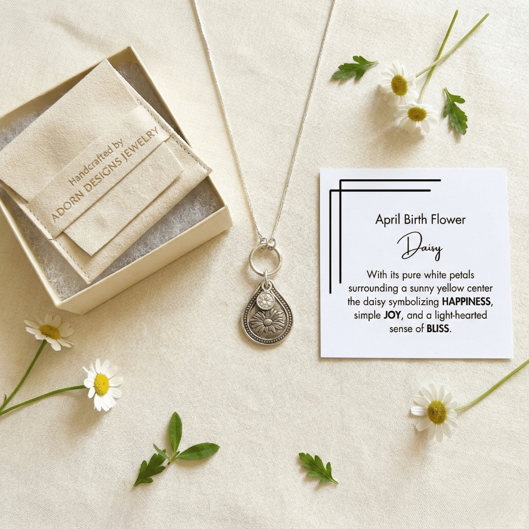 April daisy birth flower sterling silver necklace with clear diamond-like CZ stone, Adorn Designs gift box, pouch, and April daisy meaning card.
