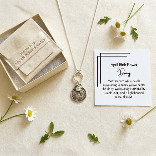April daisy birth flower sterling silver necklace with clear diamond-like CZ stone, Adorn Designs gift box, pouch, and April daisy meaning card.