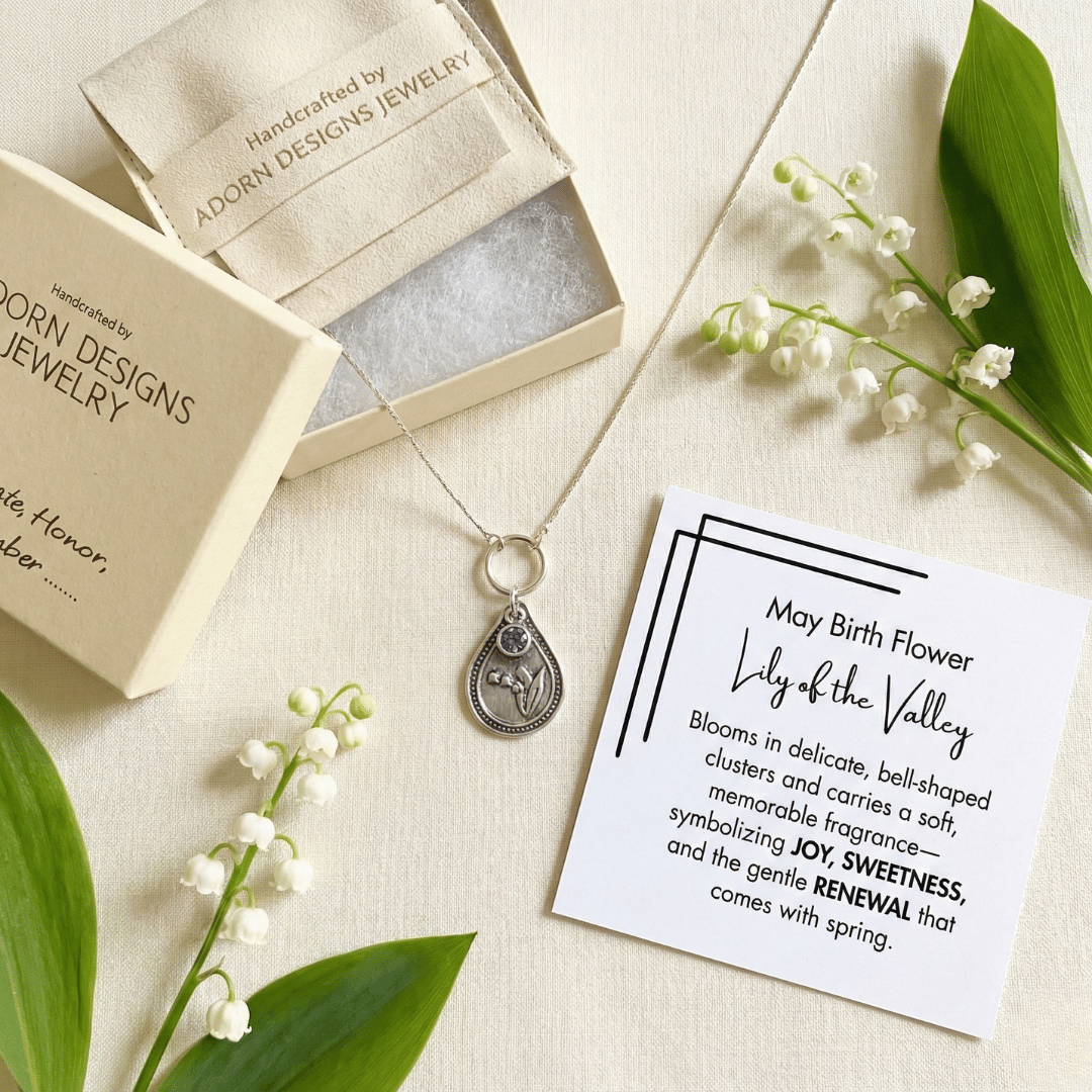 May lily of the valley birth flower sterling silver necklace with alexandrite CZ stone, Adorn Designs gift box, pouch, and May lily of the valley meaning card.