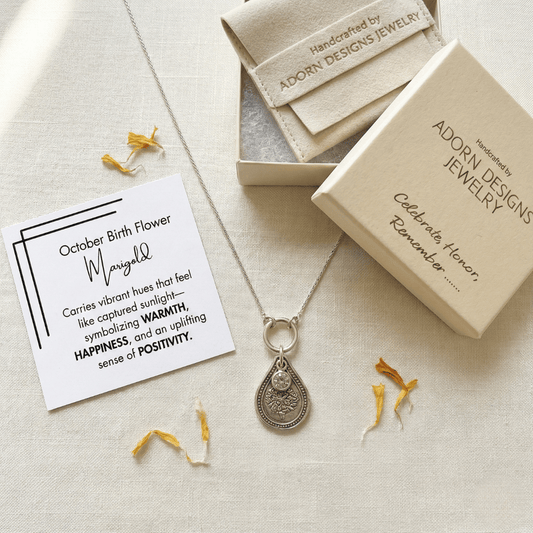 October marigold birth flower sterling silver necklace with pink tourmaline CZ stone, Adorn Designs gift box, pouch, and October marigold meaning card.