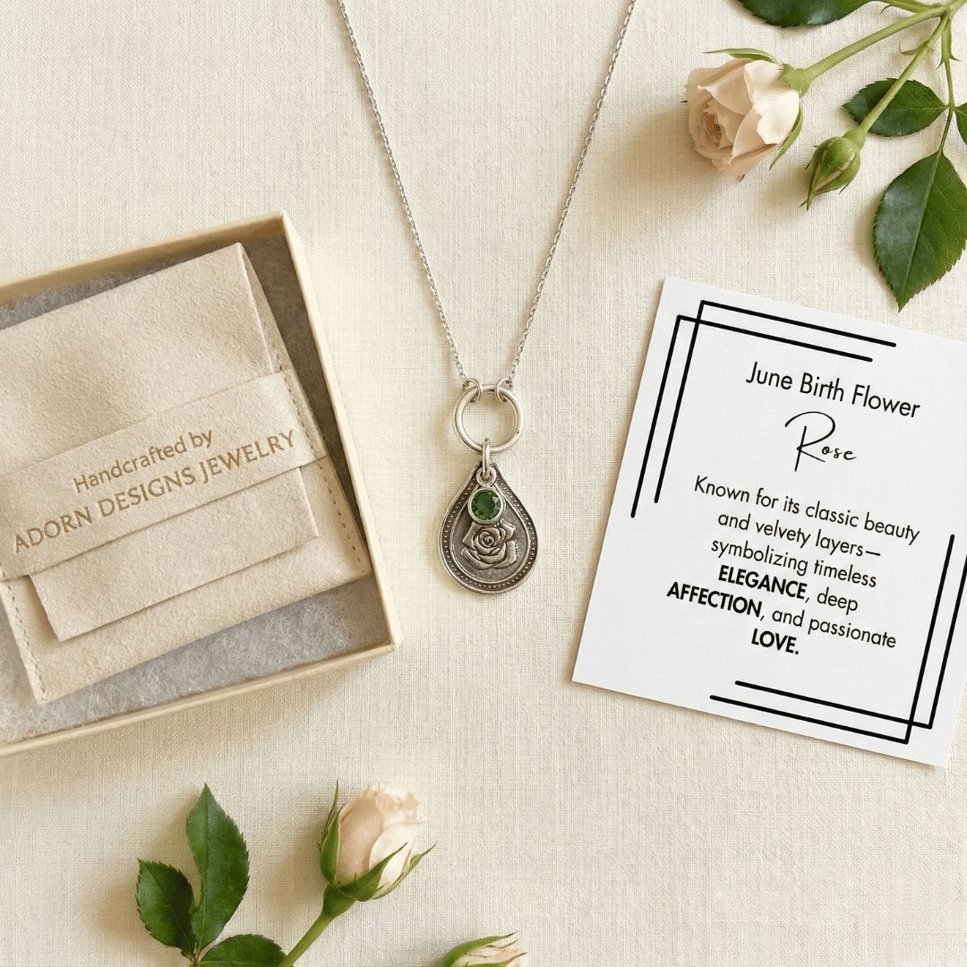 June rose birth flower sterling silver necklace with emerald-green CZ stone, Adorn Designs gift box, pouch, and June rose meaning card.