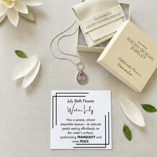 July water lily birth flower sterling silver necklace with ruby-red CZ stone, Adorn Designs gift box, pouch, and July water lily meaning card.