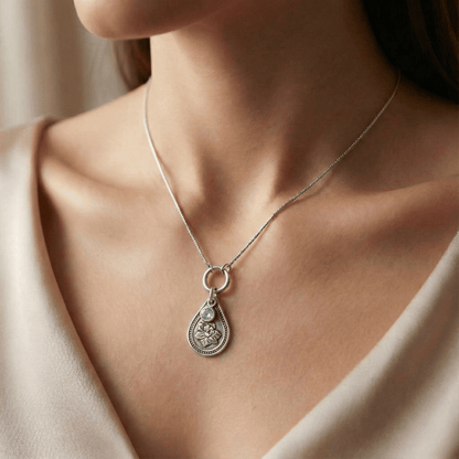 March daffodil birth flower sterling silver necklace with aquamarine CZ stone shown on neckline for scale.