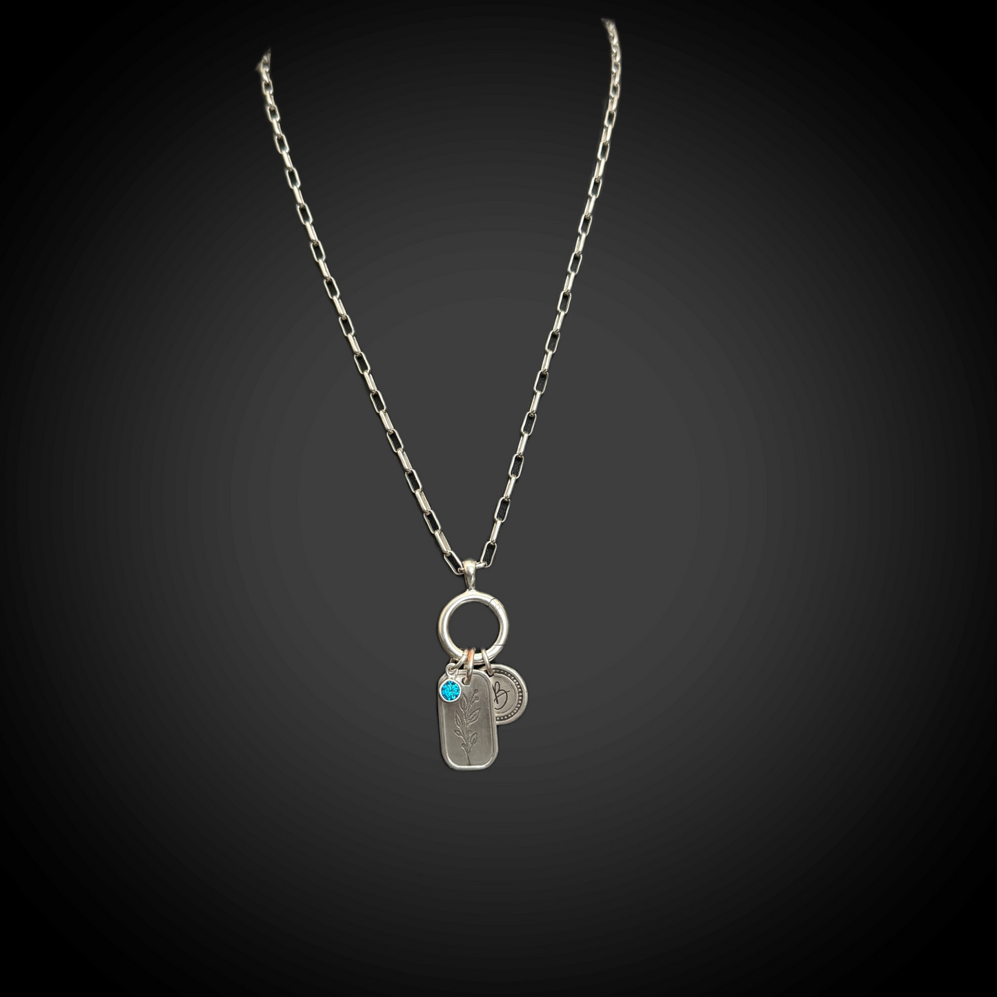 Hinged sterling charm holder with holly charm and Zircon CZ accent—overall 1 1/2 × 1/2 inch.