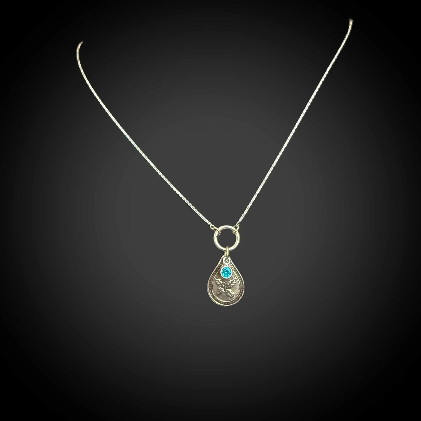 Sterling silver December birth flower necklace with holly engraving and blue zircon CZ stone by Adorn Designs Jewelry.