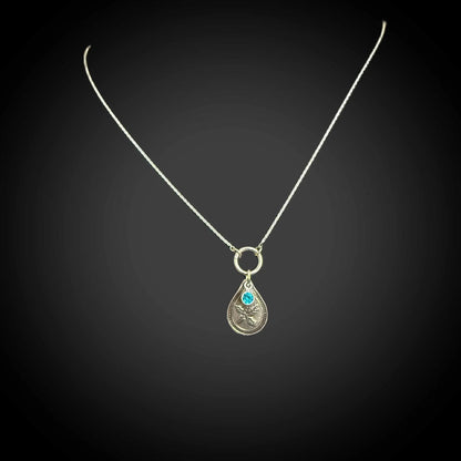 Sterling silver December birth flower necklace with holly engraving and blue zircon CZ stone by Adorn Designs Jewelry.