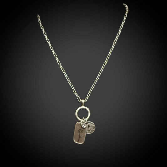 Close view of minimalist rose line engraving on 3/4 × 1/2 inch silver charm and paperclip necklace