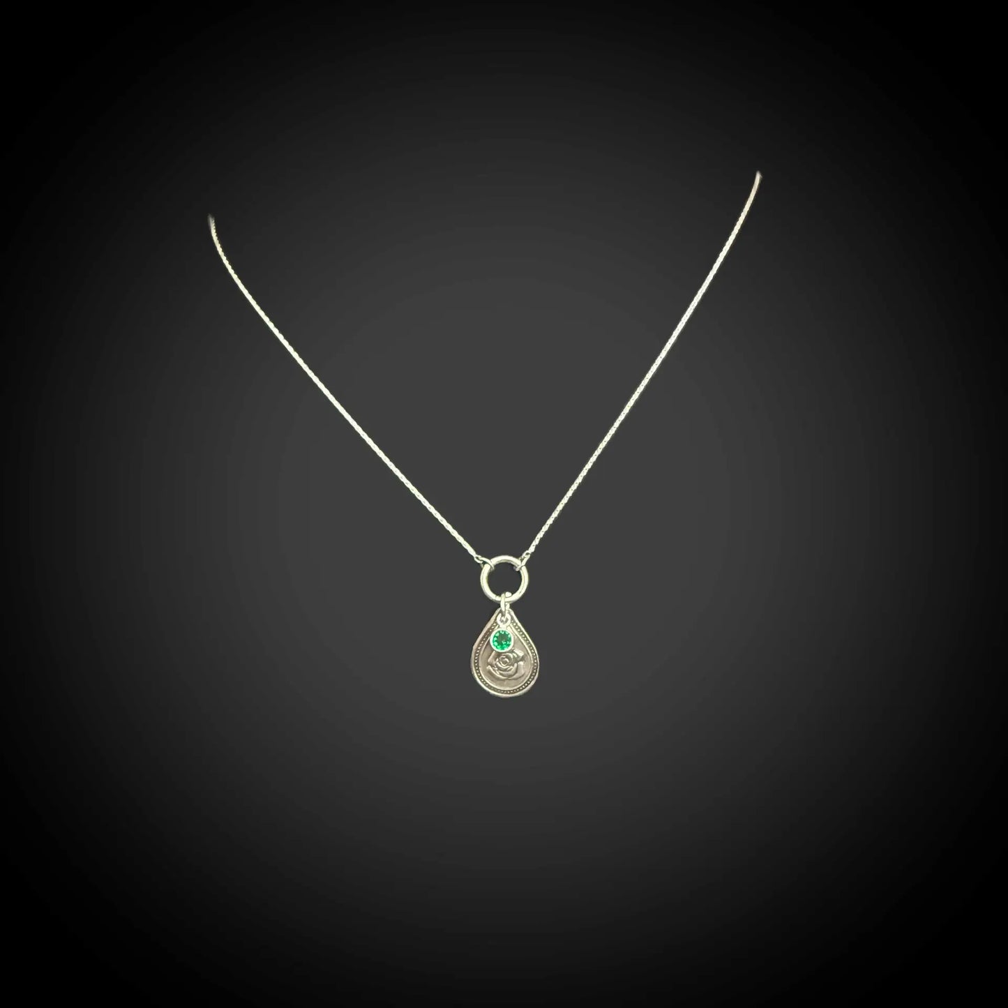 Sterling silver June birth flower necklace with rose engraving and emerald-green CZ stone by Adorn Designs Jewelry.