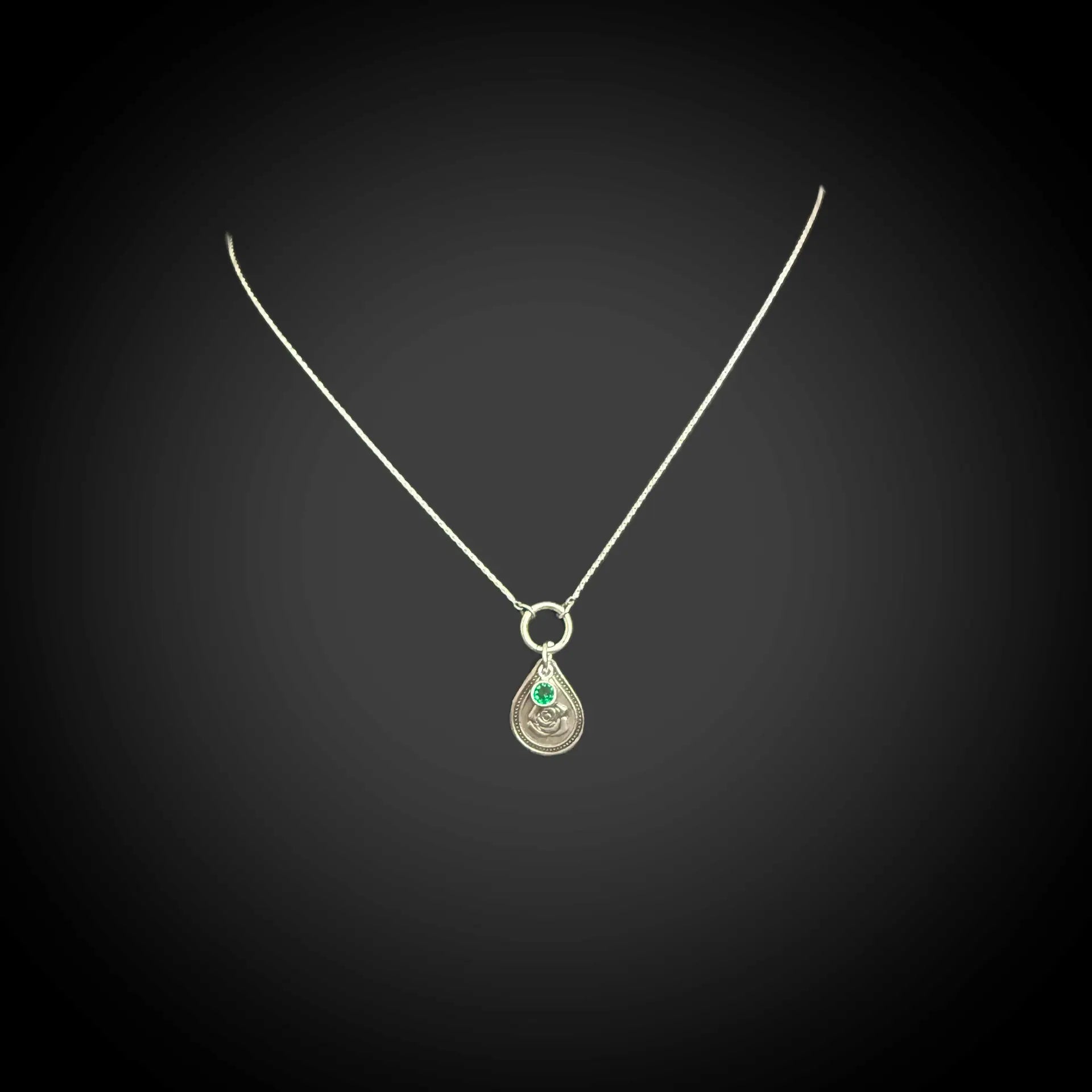 Sterling silver June birth flower necklace with rose engraving and emerald-green CZ stone by Adorn Designs Jewelry.