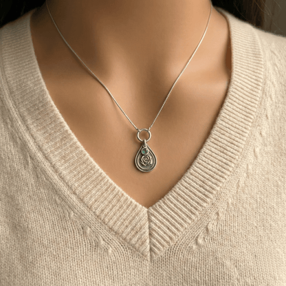 June rose birth flower sterling silver necklace with emerald-green CZ stone shown on neckline for scale.