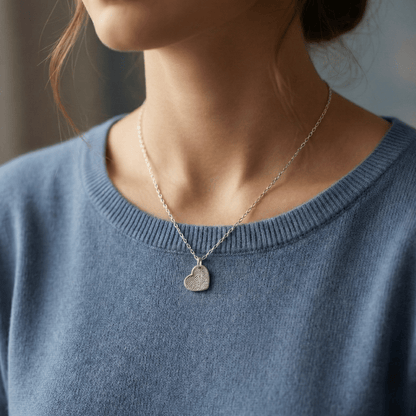 dainty fingerprint charm pendant shown on womans neckline
