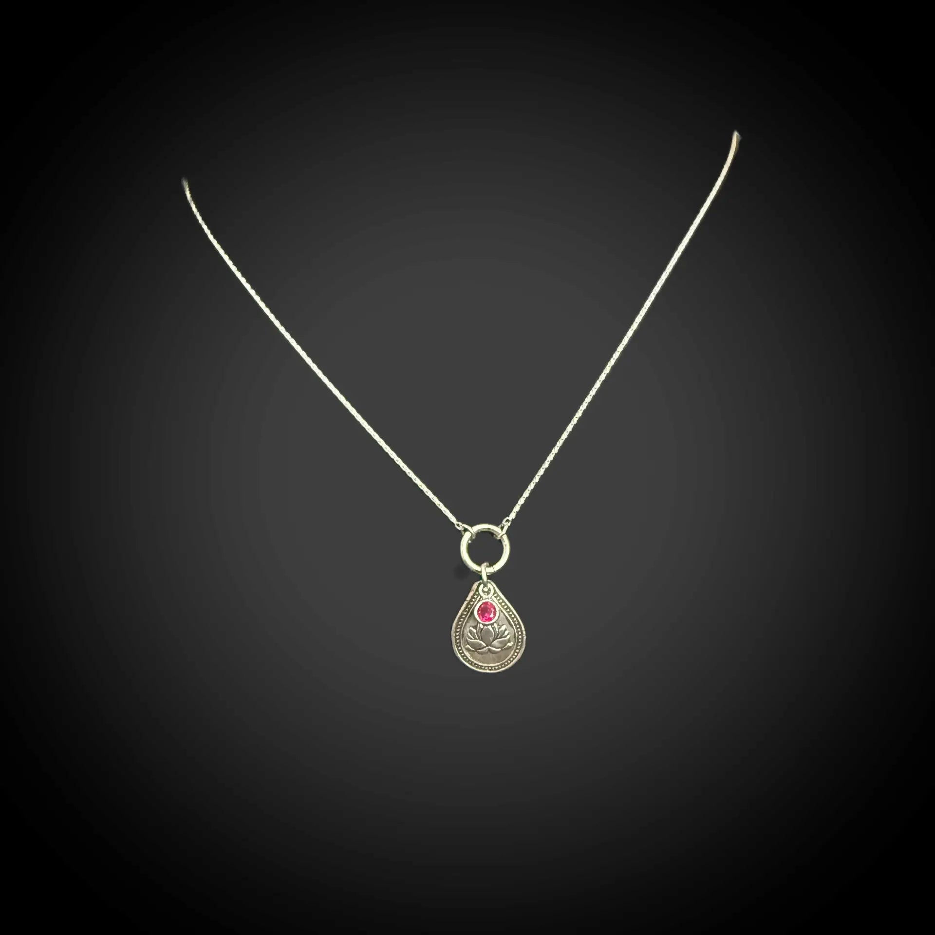 Sterling silver July birth flower necklace with water lily engraving and ruby-red CZ stone by Adorn Designs Jewelry.