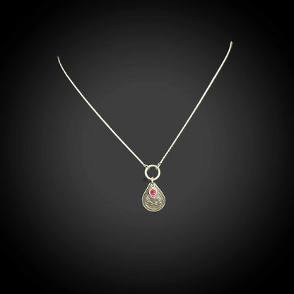 Sterling silver July birth flower necklace with water lily engraving and ruby-red CZ stone by Adorn Designs Jewelry.